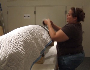 Creativity.  Rachel wrapping a canoe with blankets and stretch wrap.