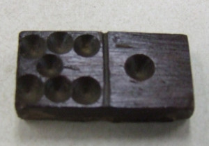 This is a wooden domino that was found in the hull of the Ronson ship.